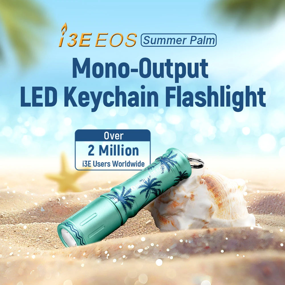 Olight Summer Palm i3E EOS Keychain Flashlight on beach sand, LED illumination for everyday carry.