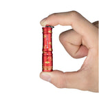 Olight Red I3E Flashlight held in fingers, detailed pattern, for everyday carry and illumination.