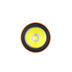 Close-up of a circular LED light, an orange and black trim frames the bright yellow light.