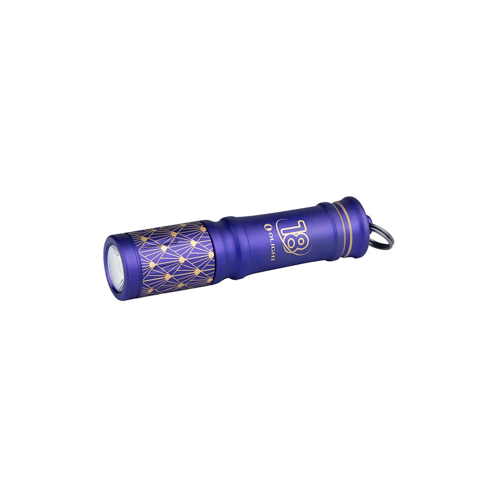 Olight Purple I3E EOS keychain flashlight with a gold geometric pattern for everyday carry.