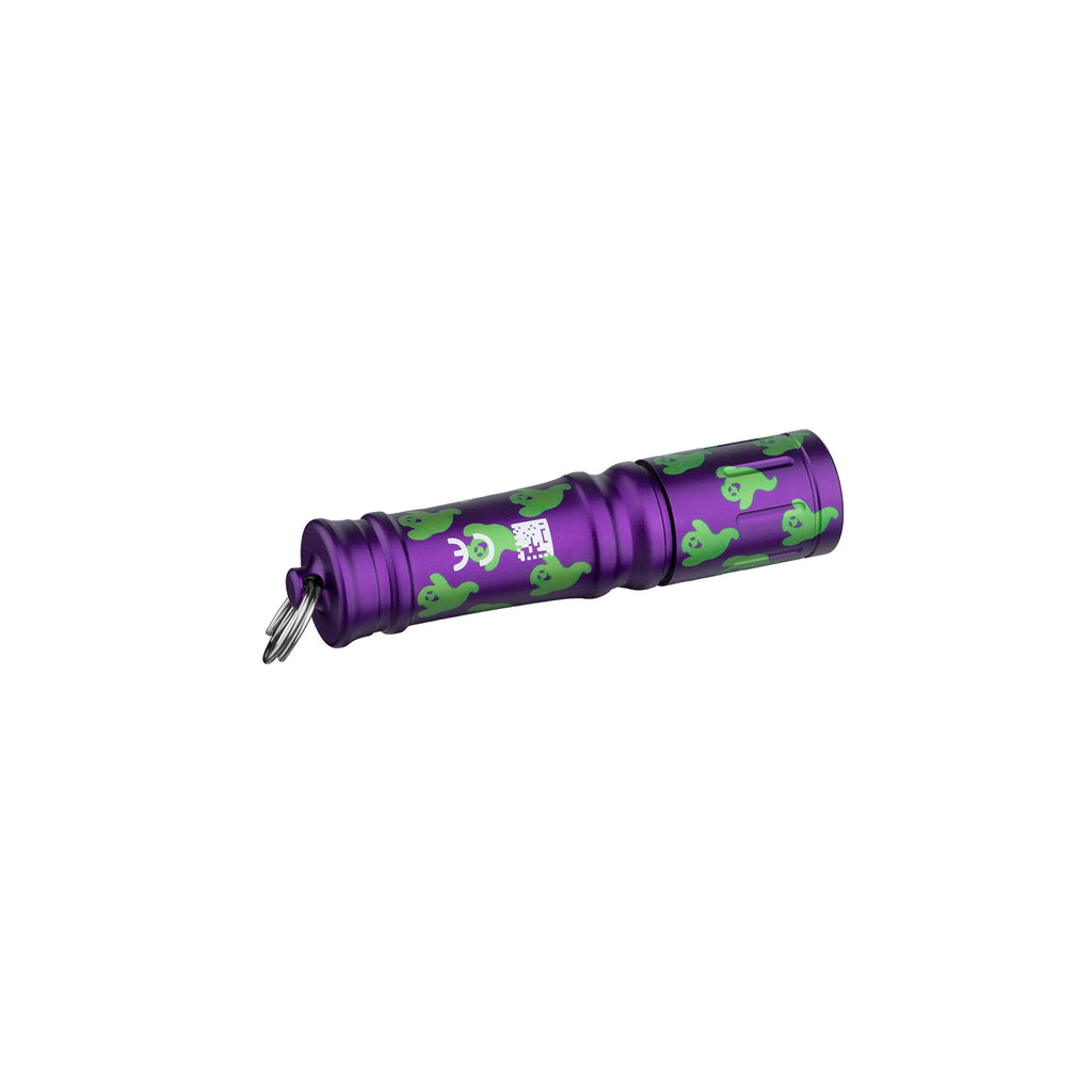 Olight Purple I3E EOS keychain flashlight with green ghost pattern, side view, portable personal illumination.