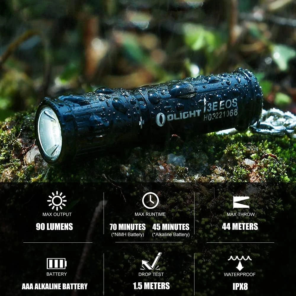 Olight Black I3E EOS Flashlight with Water Droplets on Moss for Outdoor Wet Conditions, IPX8 Waterproof.