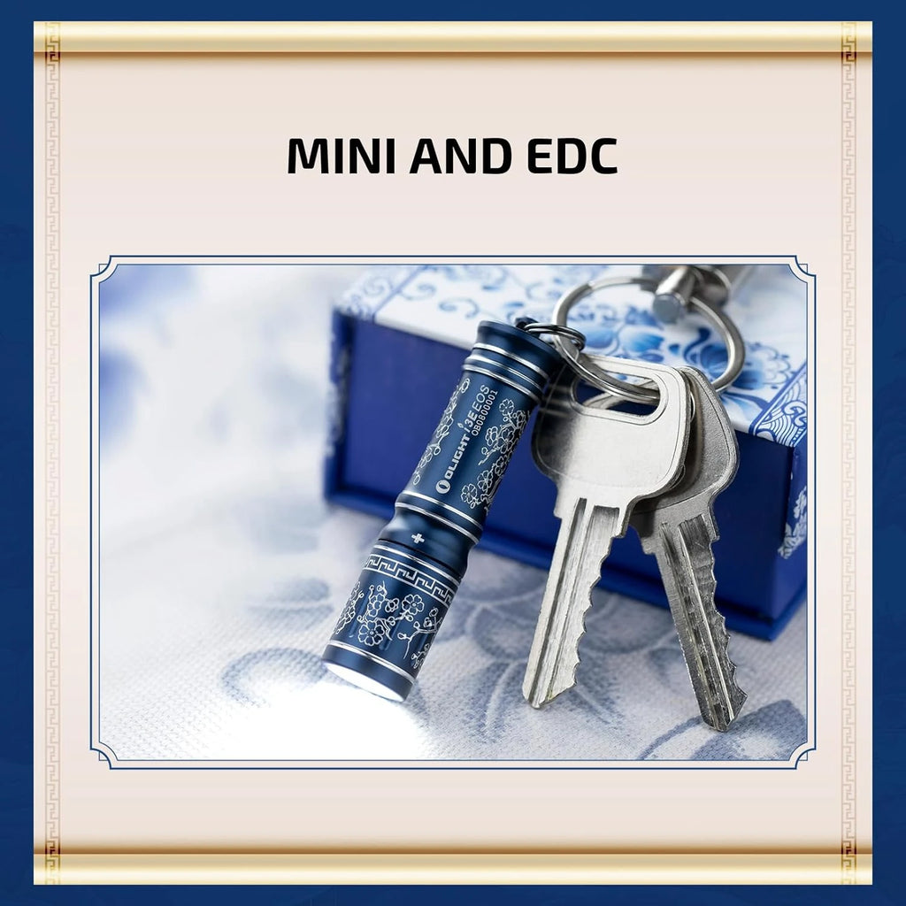 Olight I3E blue flashlight emitting light, attached to a keychain with keys, ready for EDC.