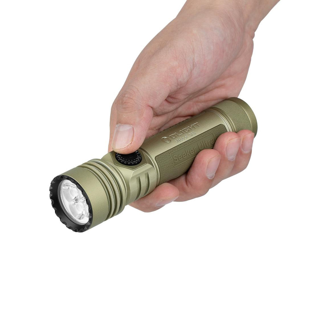 Hand holding the Olight Seeker Ultra olive green flashlight for size reference